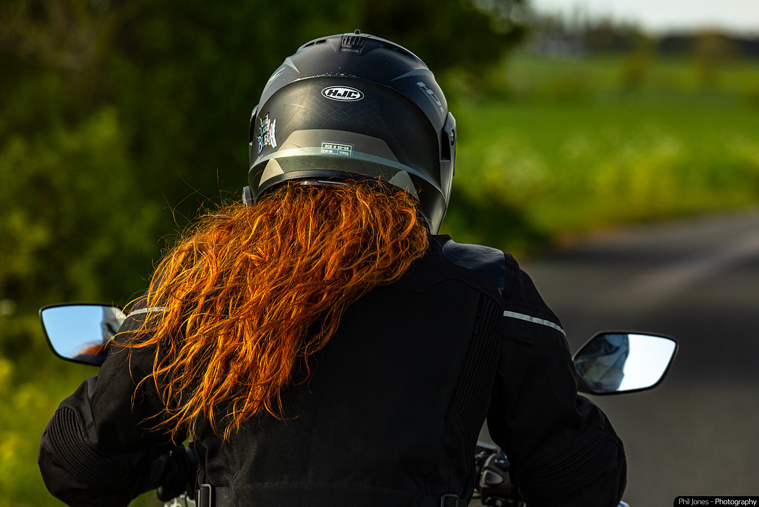 Redheaded biker girl riding her bike