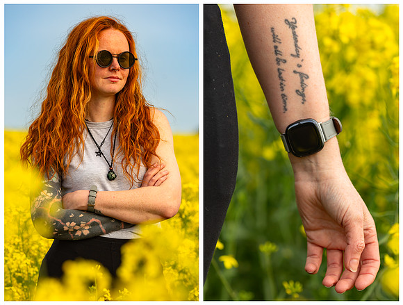 Woman with ginger hair standing in rape seed field