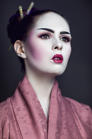 young woman pure white skin, blush purple cheeks and pumb lipstick wearing japanese geisha clothing